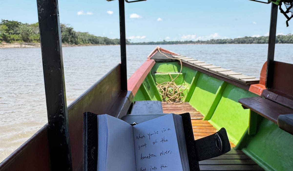 The Oh My Moment notebook on a boat in the Amazon